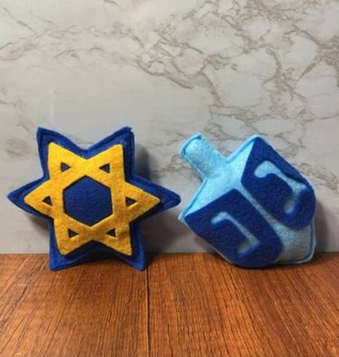 A set of Hanukkah Catnip Cat Toys in a Star of David, and dreidel design