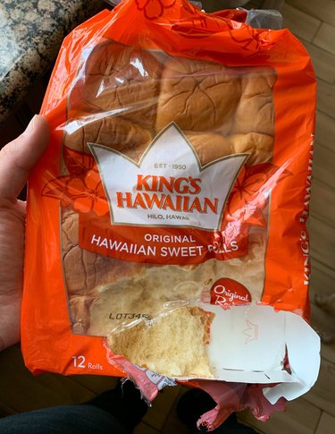 Package of Hawaiian rolls with a bite mark from a dog.