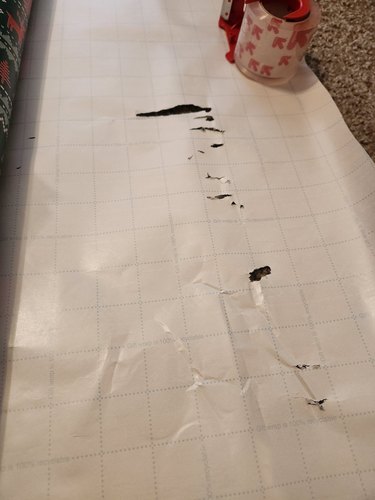 Cat leaves scratches in wrapping paper.