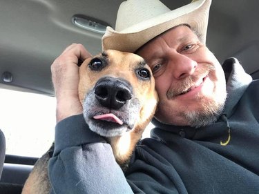 man adopts senior dog and they are smiling for the camera