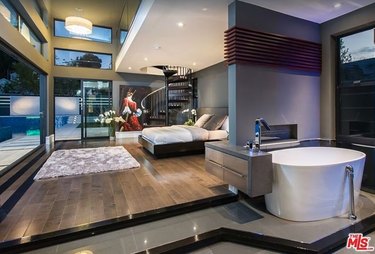 Luxury modern home interior with primary bedroom and luxury bath