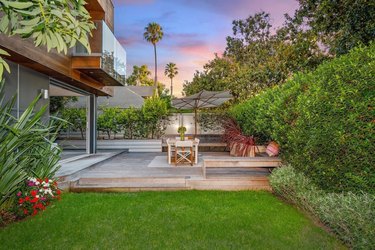 Private backyard in Santa Monica with deck, lawn, and outdoor seating