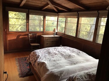 Primary bedroom with wooded view in Laguna Beach, CA home.