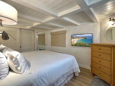 Bedroom with wall-mounted TV in Laguna Beach cottage.