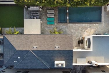 Aerial view of pool, spa, and lawn in backyard of beachside Huntington Beach home.