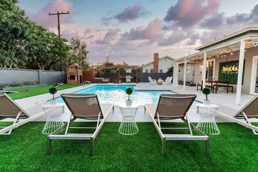 Pool and grassy resort backyard at Hakuna Matata Resort home in Anaheim