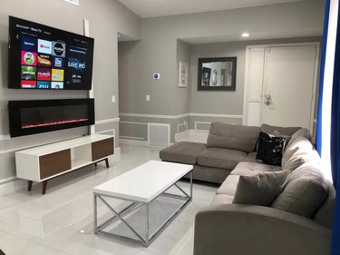 Remodeled living room with wall-mounted smart TV in Orlando, FL vacation home.