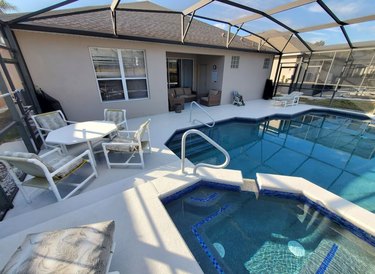 Covered lanai with swimming pool and hot tub.
