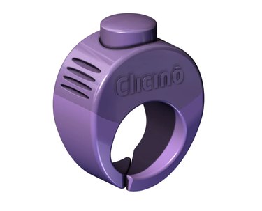 Clicino clicker ring in purple against a white background. The button is positioned at the top of the ring and the opening for your finger isn't closed so it's somewhat adjustable.