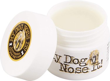 A jar of My Dog Nose It! Sun Protection Balm with the lid off. It looks to have a waxy consistency and is solid.