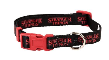 Stranger Things collar against a white background. The collar is black with red logos printed on it, red plastic buckels, and a nickel-plated D-ring for attaching a leash. It's pictured against a white background.