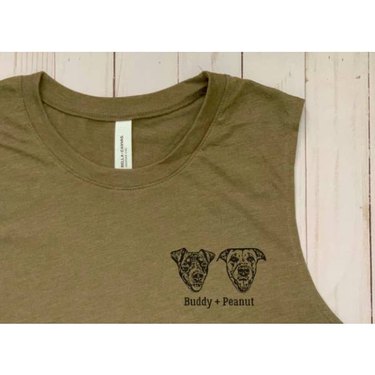 A close-up image of an olive green tank top with two small pet portraits and their names printed on it.