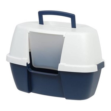 A white and blue IRIS USA Jumbo Hooded Litter Box with a handle in a verticle L-shape for easy storage.