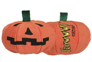 Jack-o'-lantern catnip-filled toy with a green stem and the Yeowww! logo on its side.