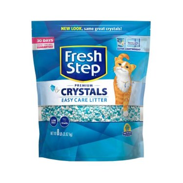 An 8-pound bag of Fresh Step crystal cat litter against a white background. The crystals look like pea gravel and are light blue and white in color.