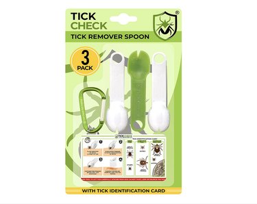 Three spoon-shaped tick removal tools, a carabiner, and a waterproof tick identification card.