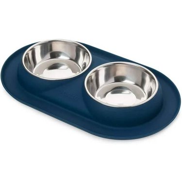 A Bonza Double Cat Bowls set in a blue mat for collecting spills