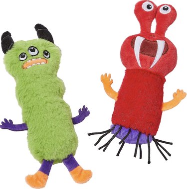 Two catnip and crinkle material-infused plush monster toys. One is green with horns and three eyes and the other is red with fangs and tentacles.