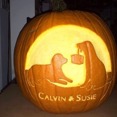 dogs carved into pumpkin
