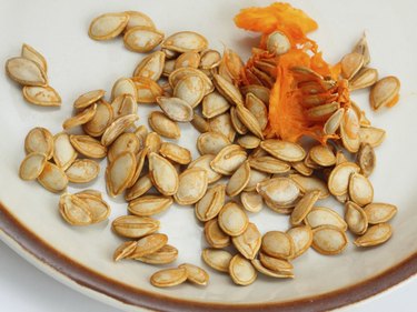 Pumpkin seeds with a pulp on a plate