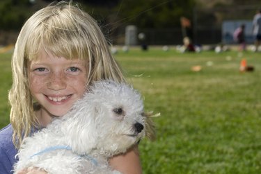 Happy child hugging her best friend.