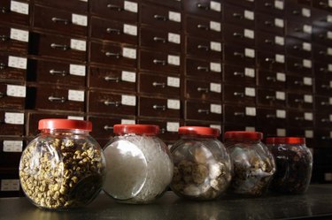 Row of Chinese medicinal herbs in jars