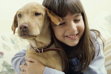 Close-up of a girl holding her dog