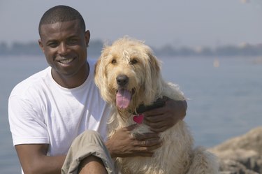 African man with dog at beach
