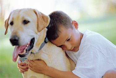 Boy hugging dog