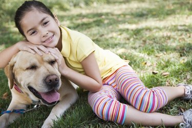 Girl embracing dog