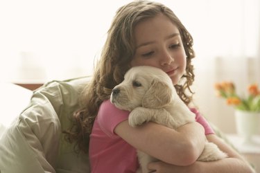 Young girl holding puppy