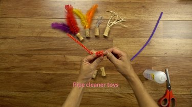 Bending pipe cleaner for DIY cat toys out of wine corks