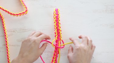 Tying square knots around handle
