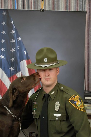 Police dog kisses unexpectedly during photoshoot