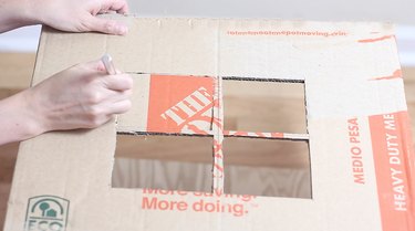 cutting window out on side of box