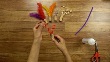 DIY cat toys out of a wine cork and pipe cleaner.