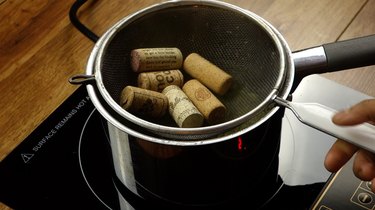 Steaming wine corks for DIY cat toys out of wine corks.