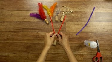 Bending pipe cleaner for DIY cat toys out of wine corks