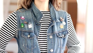 Woman wearing denim vest with kitty flair pins