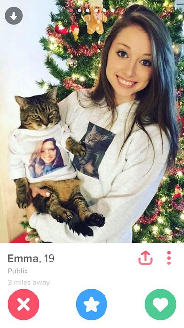 Girl and cat wearing t-shirts with the other's face on Tinder