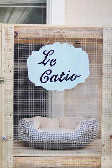 "Le Catio" sign hanging on front of catio