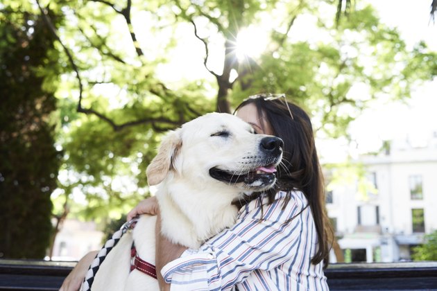 Young woman hugging her dog