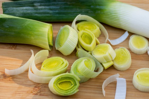 chopped leeks on a wooden cutting board