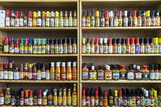 Jars of hot sauce on shelves in store