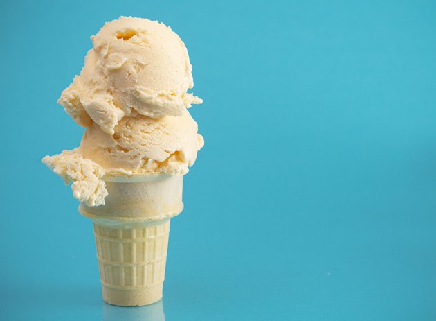 Double Scoop Vanilla Ice Cream Cone on a Blue Background