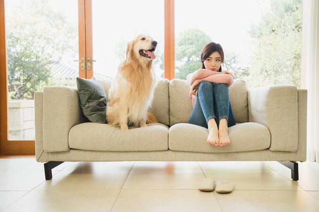 A sad woman and a dog sitting next to her