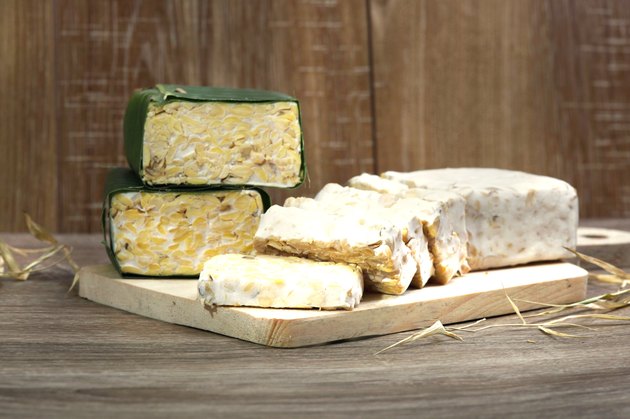 slices of raw Tempeh on cutting board