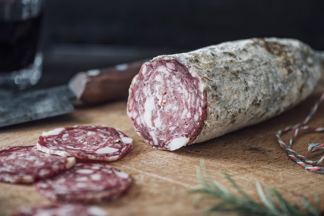 Sliced salami on cutting board