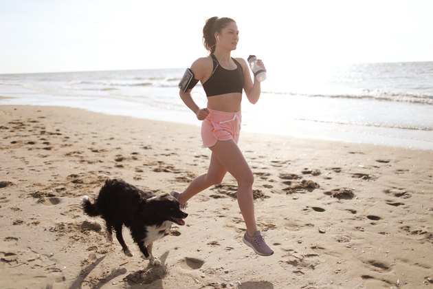 A young woman running on the beach