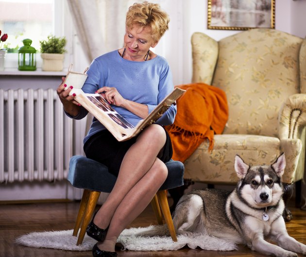 Senior woman and dog at home.